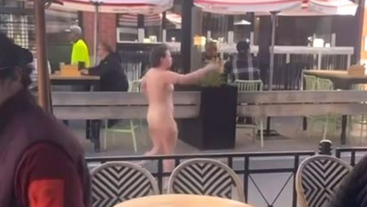 A woman walks down Little Malop St naked on Thursday.