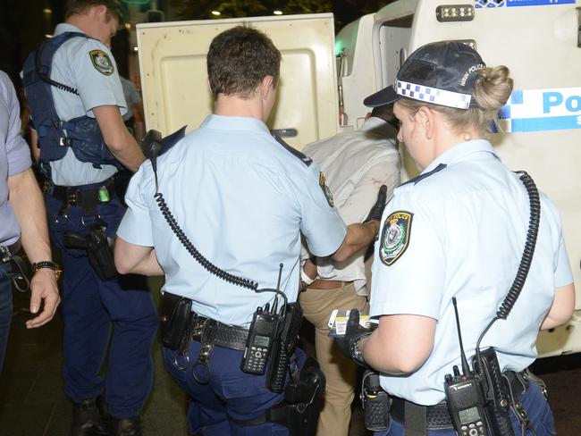 Police lead a man away from The Ivy nightclub on George St after reports of a fight between two men. Picture: Gordon McComiskie