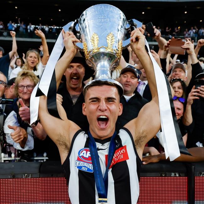 Nick Daicos soaks up the premiership win with the Collingwood army. Picture: Dylan Burns/AFL Photos via Getty Images