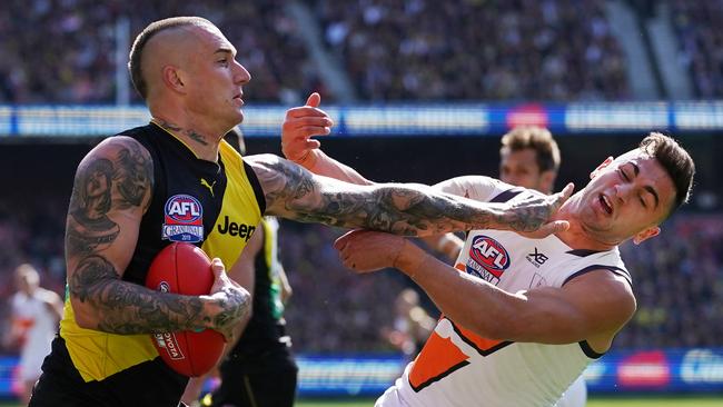 Dustin Martin fends off Tim Taranto en route to claiming his second Norm Smith Medal. Picture: AAP Image/Michael Dodge.