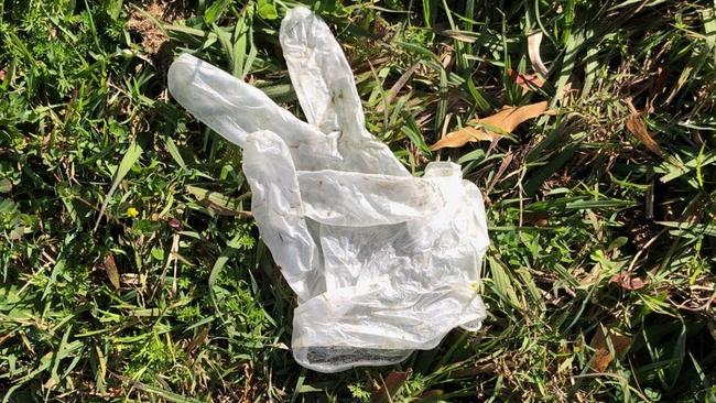 A disposable glove left on the footpath after police conducted random breath tests at a Slacks Creek site this morning.