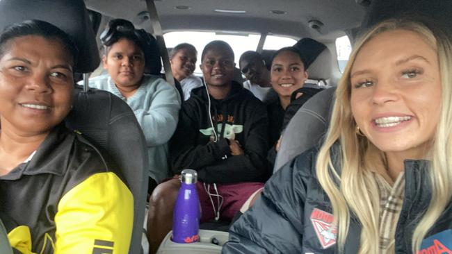 Previous participants in Essendon’s First Nations Women's Pathway Program are pictured on the road with Courtney Ugle, who said she regards the players as her “little sisters”. Picture: supplied