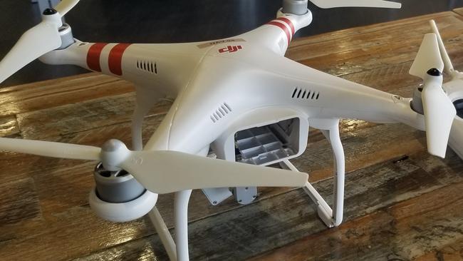 A woman has been fined after getting a drone to deliver a pack of cigarettes to hotel quarantine.