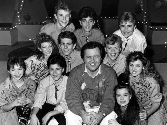 The Young Talent Time team in 1987, from back L-R: singer Bevan Addinsall with Vince Del Vito, Mark Stevens. (Middle row) Natalie Miller, Tim Nelson, Greg Poynton. (Front) Juanita Coco, Joey Dee, TV presenter Johnny Young, Courtney Compagnino and Dannielle (later Dannii) Minogue.