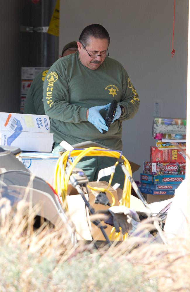 Police teams search the garage on 18 January, 2018. Board games and a baby’s first slide box can be seen. Picture: Mega