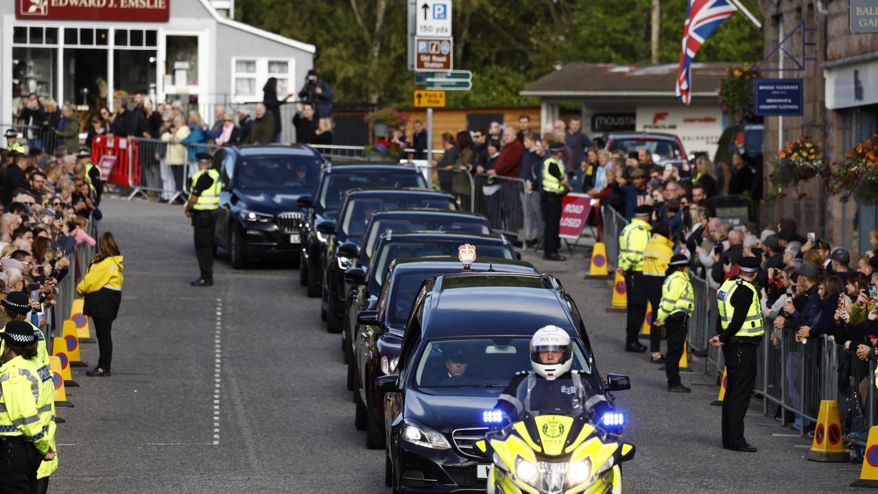 Queen Elizabeth’s death sparked a series of coded operations, which detailed plans to follow after she died. Pictured here are people gathered in tribute as the cortege carrying the coffin of the late Queen Elizabeth II passes by on September 11 in Ballater. Picture: Getty Images)