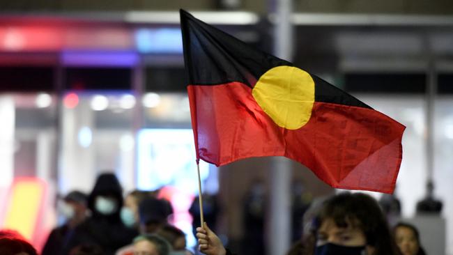 The Aboriginal flag is seen during a Stop Black Deaths in Custody: Solidarity with Long Bay Prisoners vigil at Sydney Town Hall in Sydney on Friday.