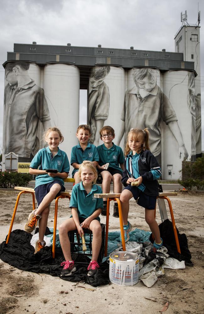 Ciara Johnson, Reef Gregor, Blake Thompson, Kiarah Leske and Macey Jacobs in front of their paintings on the 30-metre high Coonalpyn silo mural by artist Guido van Helten. Picture: Matt Turner