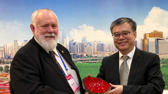 Bundaberg Regional Council’s Bill Trevor presents a gift to the city of Nanning Deputy Mayor Liu Weimin during a formal function in Nanning in 2019.