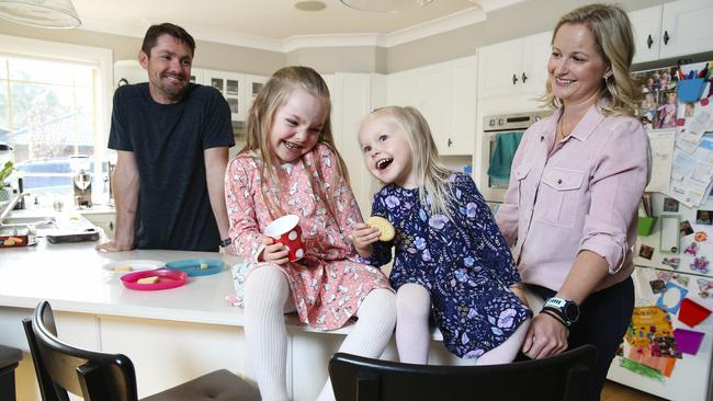 Peter and Erin Ingram with their daughters Amelia, 4, and Madeline, 3, at home today. Picture: Justin Lloyd