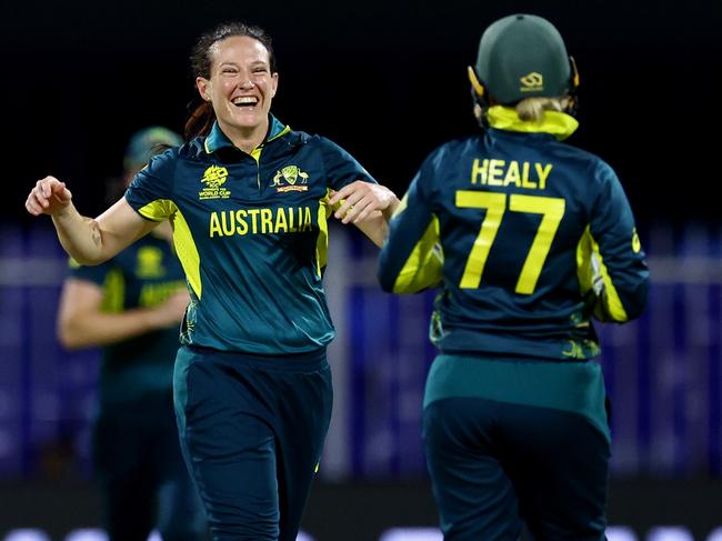 SHARJAH, UNITED ARAB EMIRATES - OCTOBER 08: Megan Schutt of Australia celebrates with teammate Alyssa Healy after dismissing Georgia Plimmer of New Zealand (not pictured) during the ICC Women's T20 World Cup 2024 match between Australia and New Zealand at Sharjah Cricket Stadium on October 08, 2024 in Sharjah, United Arab Emirates.  (Photo by Francois Nel/Getty Images)