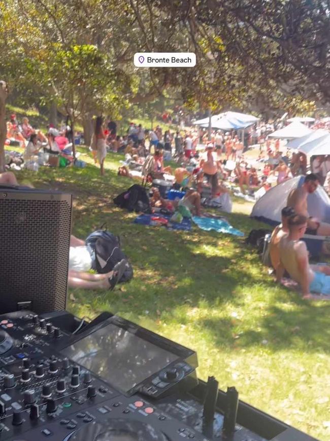 An industrious DJ has set up decks and a speaker on the beachfront park. Image: Instagram