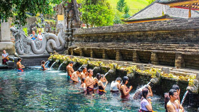 Prayer and purification at Tirta Empul temple on Bali, Indonesia.