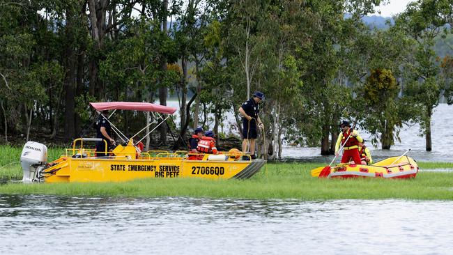 SES and Queensland Fire and Emergency Service boats searched for the body of a missing swimmer on Monday. Picture: Brendan Radke