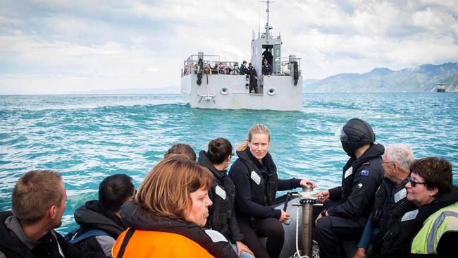 Stranded tourists being evacuated from Kaikoura to a naval ship as a fleet of international warships began arriving in the disaster zone. Picture:AFP/NZ Defence Force