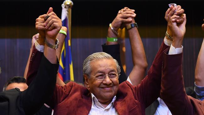 Former Malaysian prime minister and opposition candidate Mahathir Mohamad celebrates with other leaders of his coalition. Picture: AFP