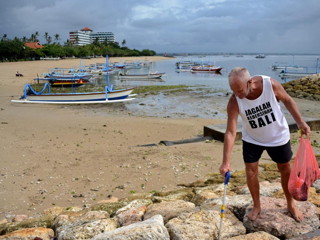 Australian man Paul Gibson picks up rubbish at the beach in Sanur on December 18. Picture: Sonny Tumbelaka/AFP