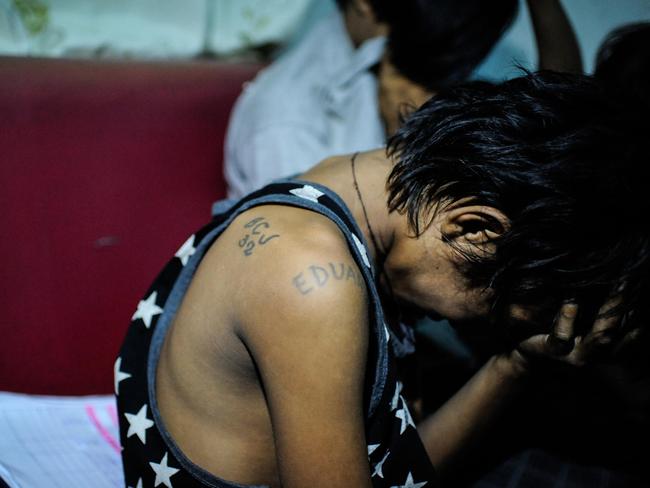 Eduardo, a 13-year-old underage member of a prison gang is picked up by police during a night time drug raid in a shanty community in Manila in June. The youngster is one of thousands to be targeted by a tough crackdown on criminal activity. Picture: Dondi Tawatao