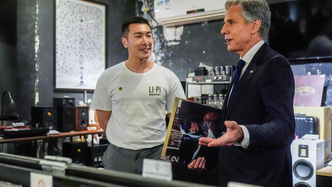 US Secretary of State Antony Blinken (R) talks with Yuxuan Zhou during a visit to Li-Pi record store in Beijing on April 26, 2024. (Photo by Mark Schiefelbein / POOL / AFP)