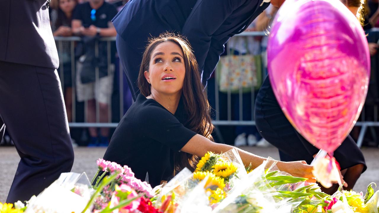 Meghan looks at floral tributes laid by members of the public on the Long Walk at Windsor Castle. (Photo by Chris Jackson - WPA Pool/Getty Images)