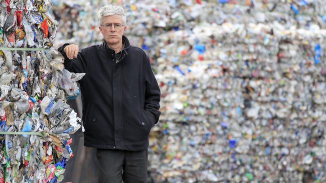 Tasmanian Conservation Trust director Peter McGlone among the bales of plastics at the SKM recycling plant in Derwent Park. <source>Picture: ROB BLAKERS</source>