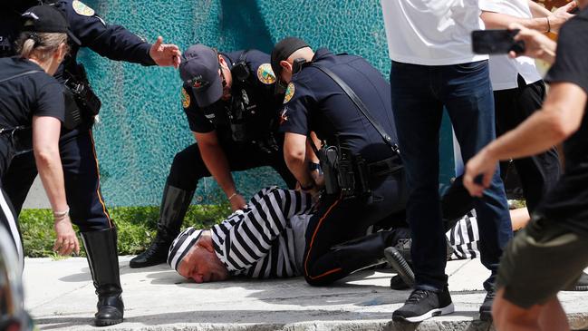 Demonstrator Dominic Santana is detained by Miami police after trying to block former President Donald Trump's motorcade as it departed the courthouse. Picture: Octavio Jones/Getty Images/AFP