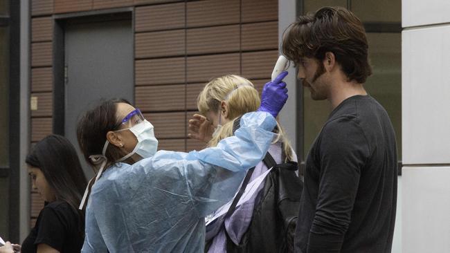 People queue at the Royal Melbourne Hospital to be tested for coronavirus. Picture: Tony Gough