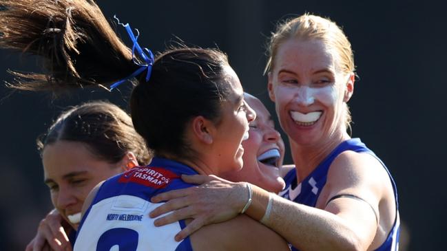 BRISBANE, AUSTRALIA - SEPTEMBER 01: Vikki Wall, Taylah Gatt and Kate Shierlaw of the Kangaroos celebrate a goal during the round one AFLW match between Brisbane Lions and North Melbourne Kangaroos at Brighton Homes Arena, on September 01, 2024, in Brisbane, Australia. (Photo by Mackenzie Sweetnam/Getty Images)