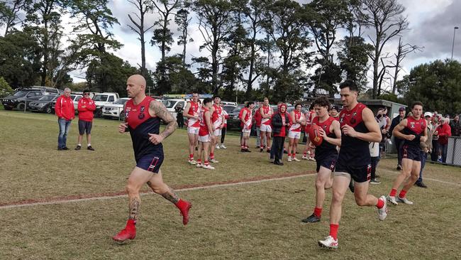 Nathan Jones and Sam Gill lead Mt Eliza on to the ground on Saturday. Picture: Valeriu Campan