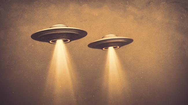 Two UFOs flying in fog with light below. 3D illustration monochromatic sepia-toned old-time photography. Concept image with blank space below the UFOs for texts and image.