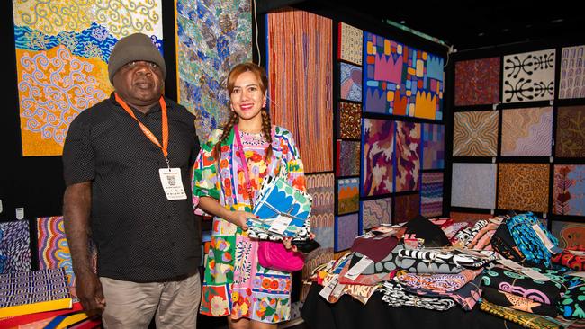 Anggie Wibowo buying a work from Ikuntji Artist Albi Jack at this year’s Darwin Aboriginal Art Fair. Picture: Pema Tamang Pakhrin