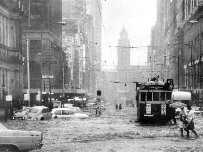 Cars are swept down Elizabeth St, during torrential rainfall in Melbourne in 1972.