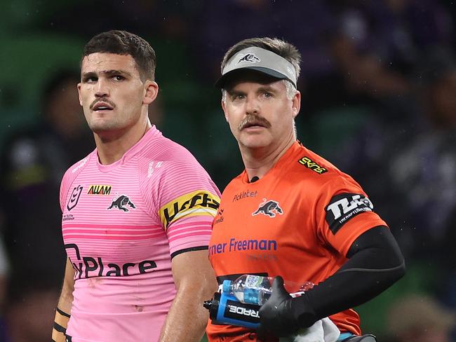 MELBOURNE, AUSTRALIA - MARCH 20: Nathan Cleary of the Panthers is assisted off the field by a trainer for a Head Injury Assessment (HIA) during the round three NRL match between the Melbourne Storm and Penrith Panthers at AAMI Park on March 20, 2025, in Melbourne, Australia. (Photo by Daniel Pockett/Getty Images)