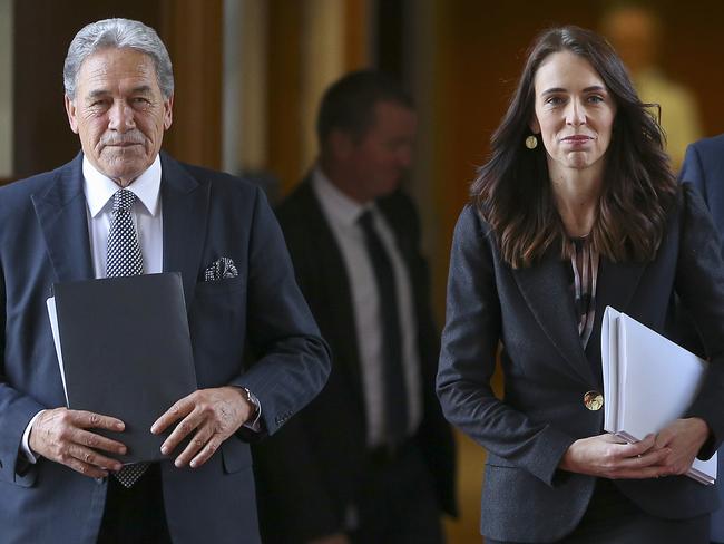 New Zealand Prime Minister Jacinda Ardern, right, walks with Deputy Prime Minister Winston Peters to the house for the budget delivery speech at Parliament in Wellington, New Zealand, Thursday, May 14, 2020. New Zealand's government plans to borrow and spend vast amounts of money as it tries to keep unemployment below 10% in the wake of the coronavirus pandemic. (Hagen Hopkins/Pool Photo via AP)