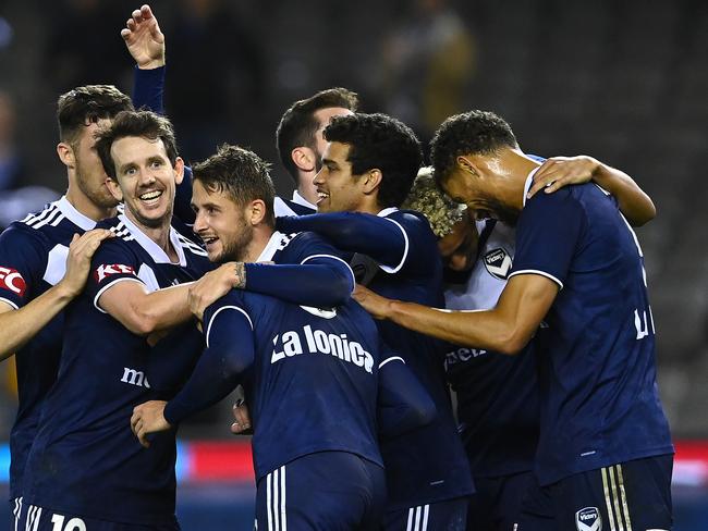 MELBOURNE, AUSTRALIA - APRIL 23:  Jacob Butterfield of the Victory is congratulated by team mates after scoring a goal during the A-League match between the Melbourne Victory and the Western Sydney Wanderers at Marvel Stadium, on April 23, 2021, in Melbourne, Australia. (Photo by Quinn Rooney/Getty Images)