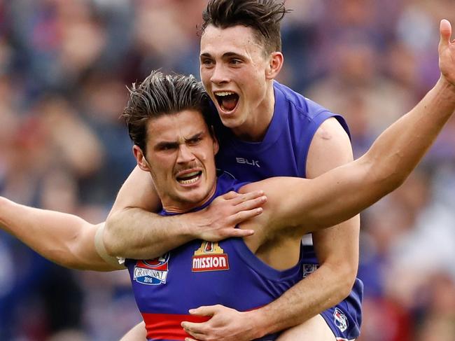 MELBOURNE, AUSTRALIA - OCTOBER 01: Tom Boyd of the Bulldogs celebrates a goal with Toby McLean of the Bulldogs during the 2016 Toyota AFL Grand Final match between the Sydney Swans and the Western Bulldogs at the Melbourne Cricket Ground on October 01, 2016 in Melbourne, Australia. (Photo by Adam Trafford/AFL Media/Getty Images)