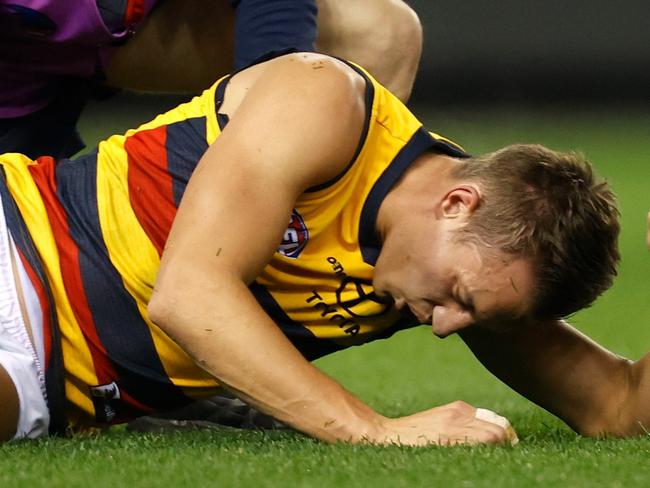 MELBOURNE, AUSTRALIA - JULY 09: Tom Doedee of the Crows lays injured during the 2021 AFL Round 17 match between the Essendon Bombers and the Adelaide Crows at Marvel Stadium on July 9, 2021 in Melbourne, Australia. (Photo by Michael Willson/AFL Photos via Getty Images)