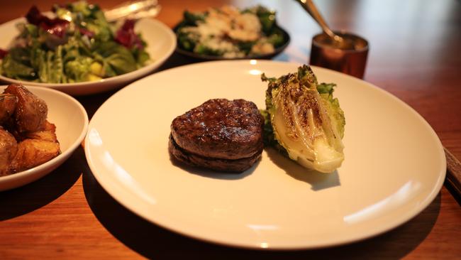 Landscape’s 30 days dry-aged, Cape Grim grass-fed sirloin steak on the bone, duck-fat pink eyes with garlic and rosemary, house salad, baby spinach, radicchio and pickled fennel, wood-fired broccolini, almonds and pecorino with Bearnaise sauce. Picture: Mireille Merlet