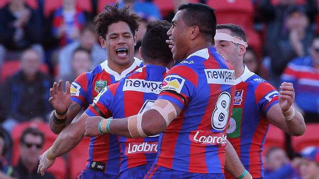 Brock Lamb of the Knights celebrates his try with teammates.