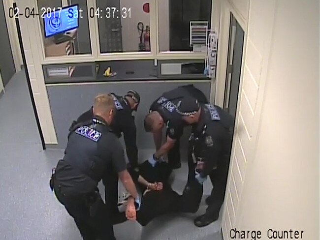 Police surround Nathan Cross while he’s on the ground.
