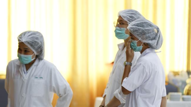 Hospital workers watch a press conference at their hospital where the rescued boys are tended to, in Chiang Rai province, northern Thailand. Picture: AP