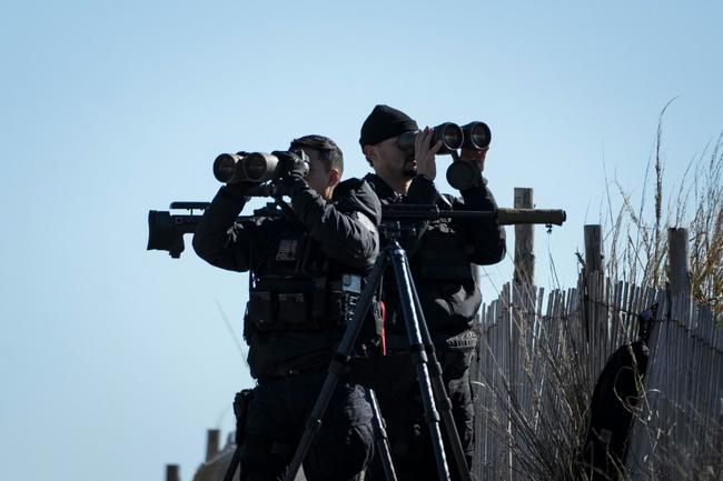 United States Secret Service counter-snipers and other security personnel keep watch as US President Joe Biden and First Lady Jill Biden board Marine One in Rehoboth Beach, Delaware