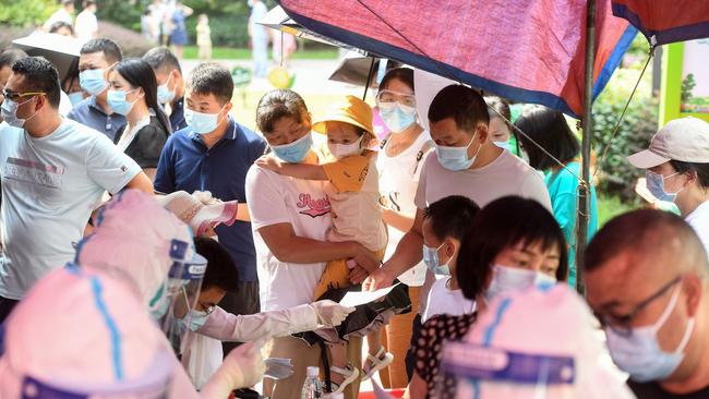 Residents queue to take nucleic acid tests for the coronavirus in Wuhan in China's central Hubei province as the city tests its entire population for Covid-19. Picture: AFP