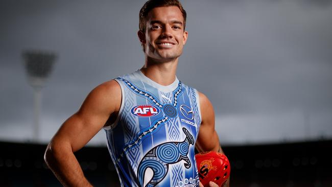 MELBOURNE, AUSTRALIA - MAY 16: Jy Simpkin of the Kangaroos poses for a photograph in the teams Indigenous guernsey during the 2022 Sir Doug Nicholls Round Launch at the Melbourne Cricket Ground on May 16, 2022 in Melbourne, Australia. (Photo by Michael Willson/AFL Photos via Getty Images)