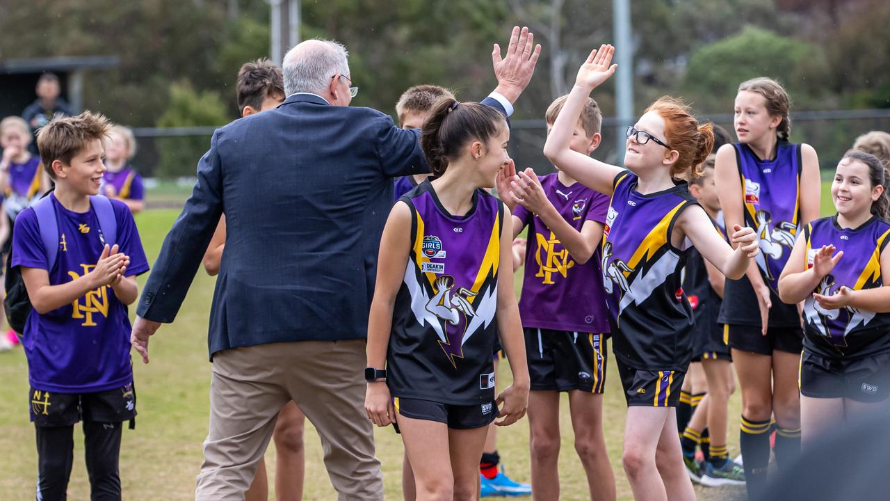 Mr Morrison high fives junior players from the Norwood Sporting Club. Picture: Jason Edwards