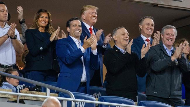 Donald Trump grinning as his image is flashed up on the big screen during game five of the World Series. Picture: Tasos Katopodis/AFP