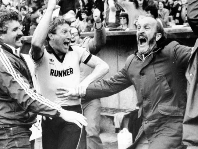 SANFL football - Glenelg reserves coach Steve Hywood (l) fitness coach Mark Coombe (c) and league coach John Halbert show their elation when the siren sounds to give Glenelg a one-point win over Port Adelaide in the preliminary final at Football Park 26 Sep 1982.