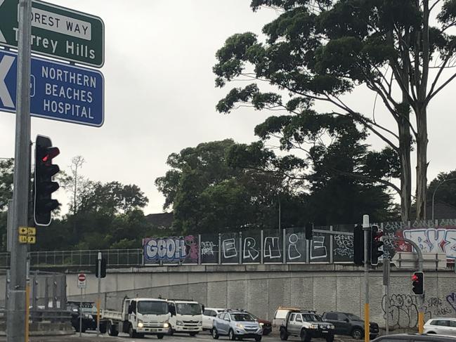 Ugly graffiti at the intersection of Warringah Rd and Forest Way, Frenchs Forest, on Monday. Transport for NSW has conformed that it will soon begin work to clean it up and prevent it from happening again. Picture: Jim O’Rourke