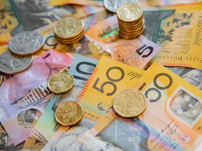 Australian notes and coins spilled out on a table