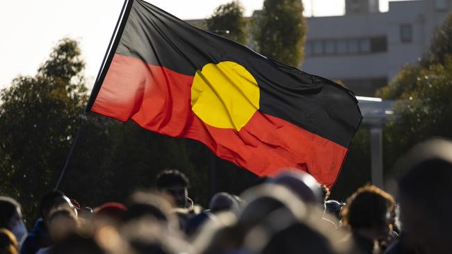 PERTH, AUSTRALIA - OCTOBER 31: The Aboriginal flag is held on October 31, 2022 in Perth, Australia. Cassius Turvey, 15, died in a Perth hospital last Sunday after he was violently assaulted in Middle Swan. Turvey was walking in the area with friends when he was assaulted. His death has triggered a wave of outrage across Australia, with many vigils and memorials taking place in several cities demanding justice. (Photo by Matt Jelonek/Getty Images)